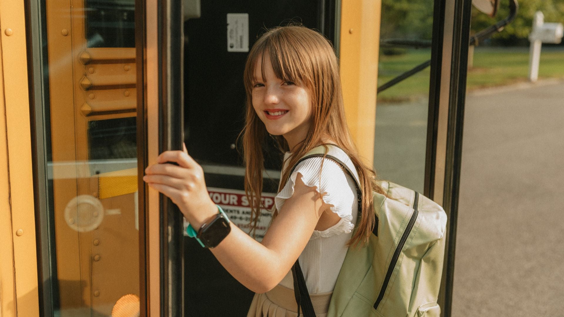 Girl boarding the school bus wearing her JrTrack 5